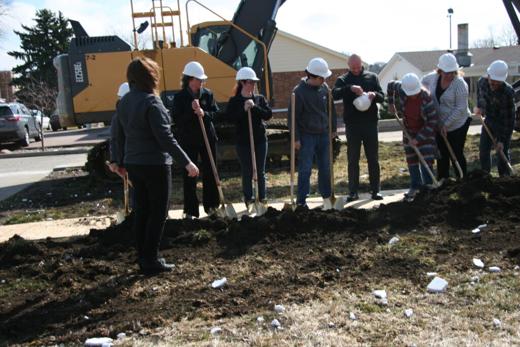 Digging into the soil for groundbreaking.