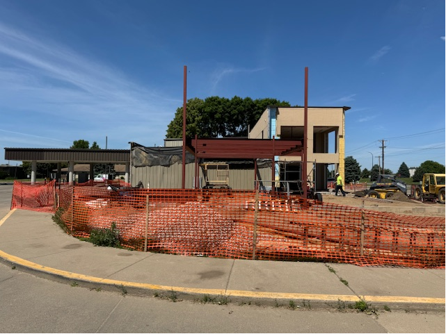 Exterior of Explorers branch under construction with orange netted fencing. 