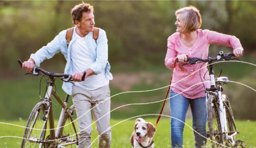 Image of Retired Couple going for a walk with their dog.