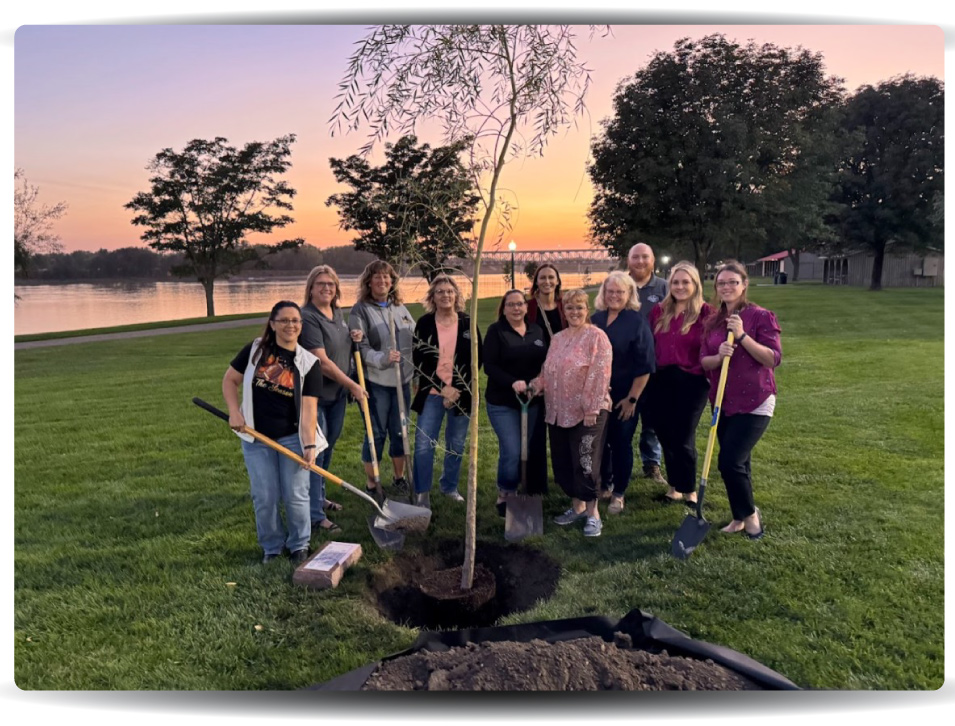 group photo of Explorers team members planting willow tree in Riverside Park