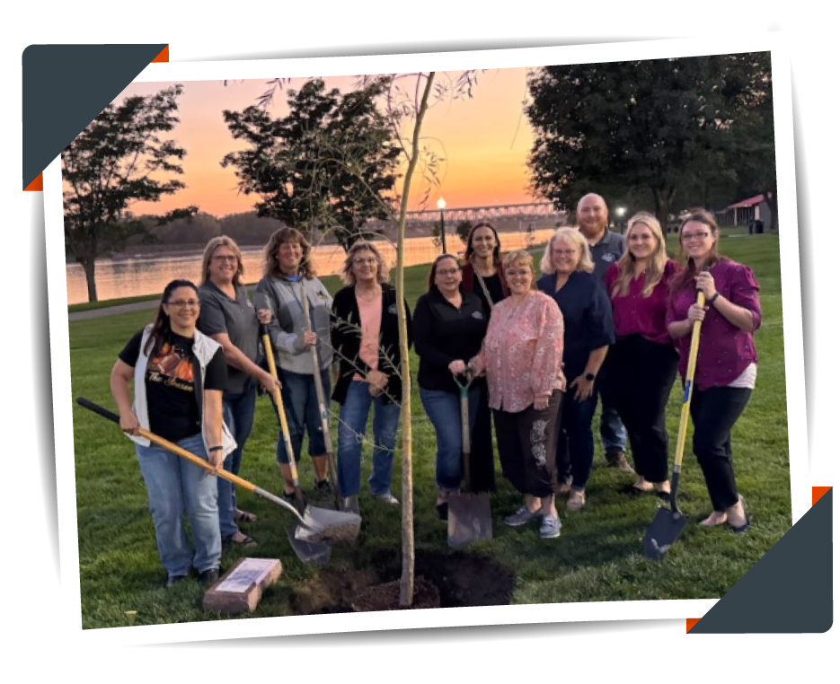 Image of Explorers Credit Union Team planting a Willow Tree in Riverside Park.