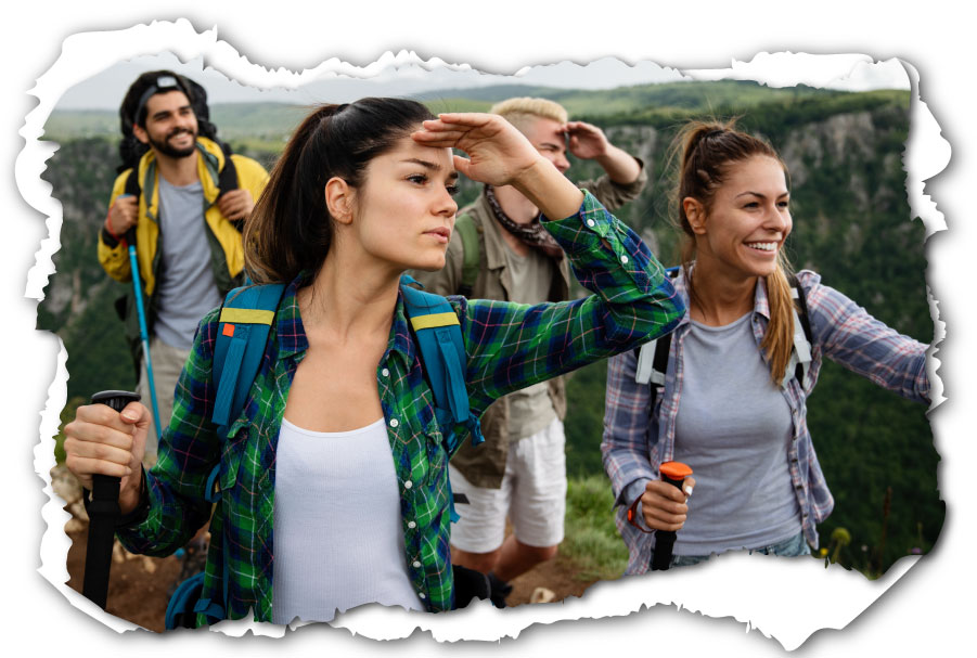 Group of young adults hiking and looking out toward the future.